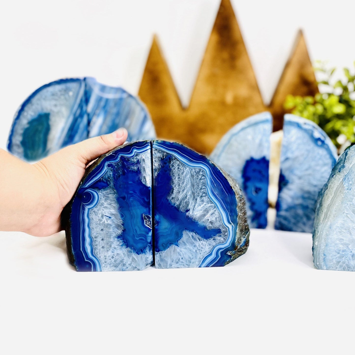 a hand next to a blue agate bookend