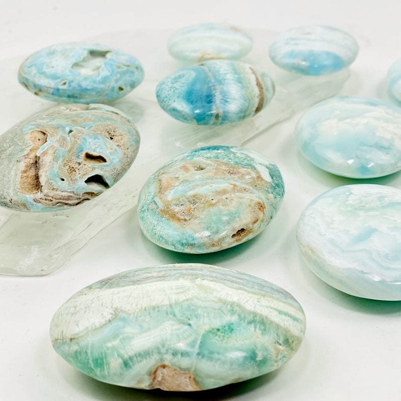side shot of blue aragonite also known as caribbean calcite palm stones to show the depth of the stone