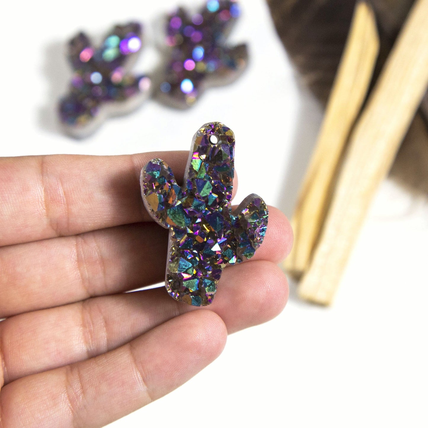 hand holding up titanium druzy cactus