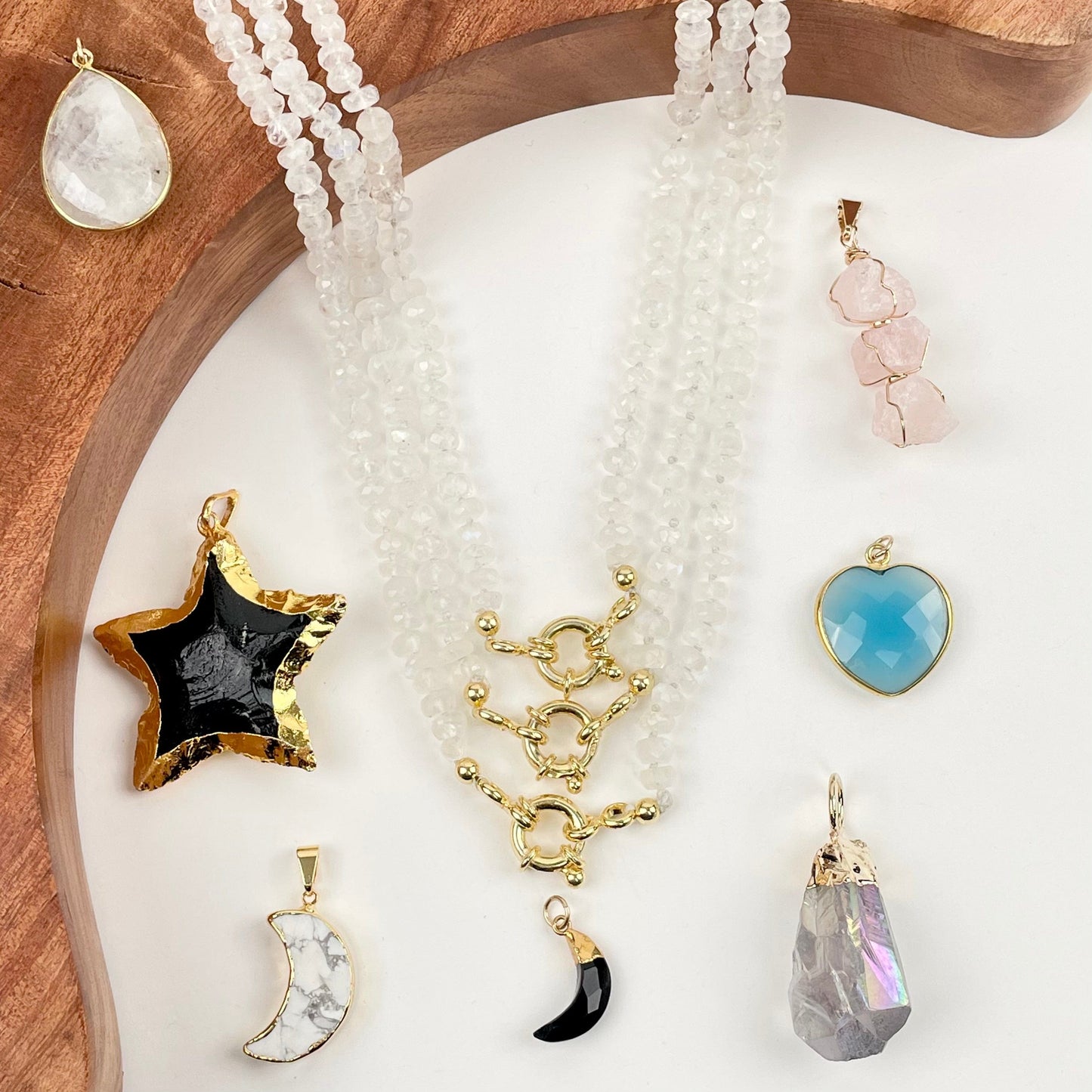 necklaces displayed with some candy necklace charms and pendants