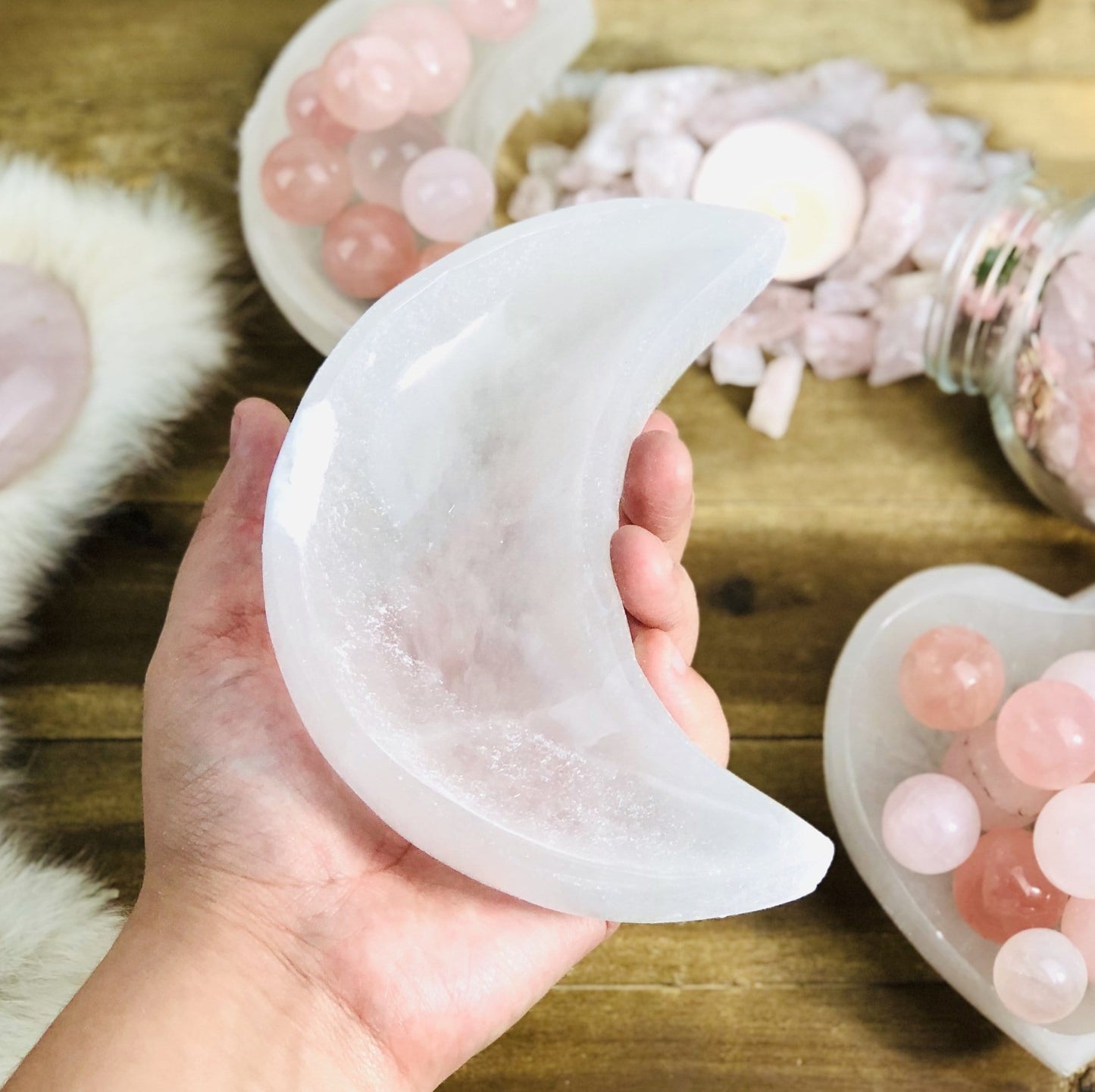 hand holding moon shaped selenite bowl