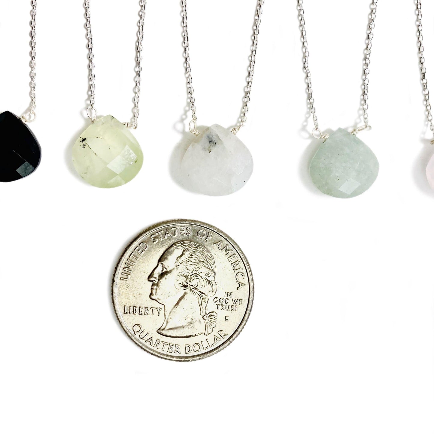 gemstone drop necklace in silver next to quarter for size reference