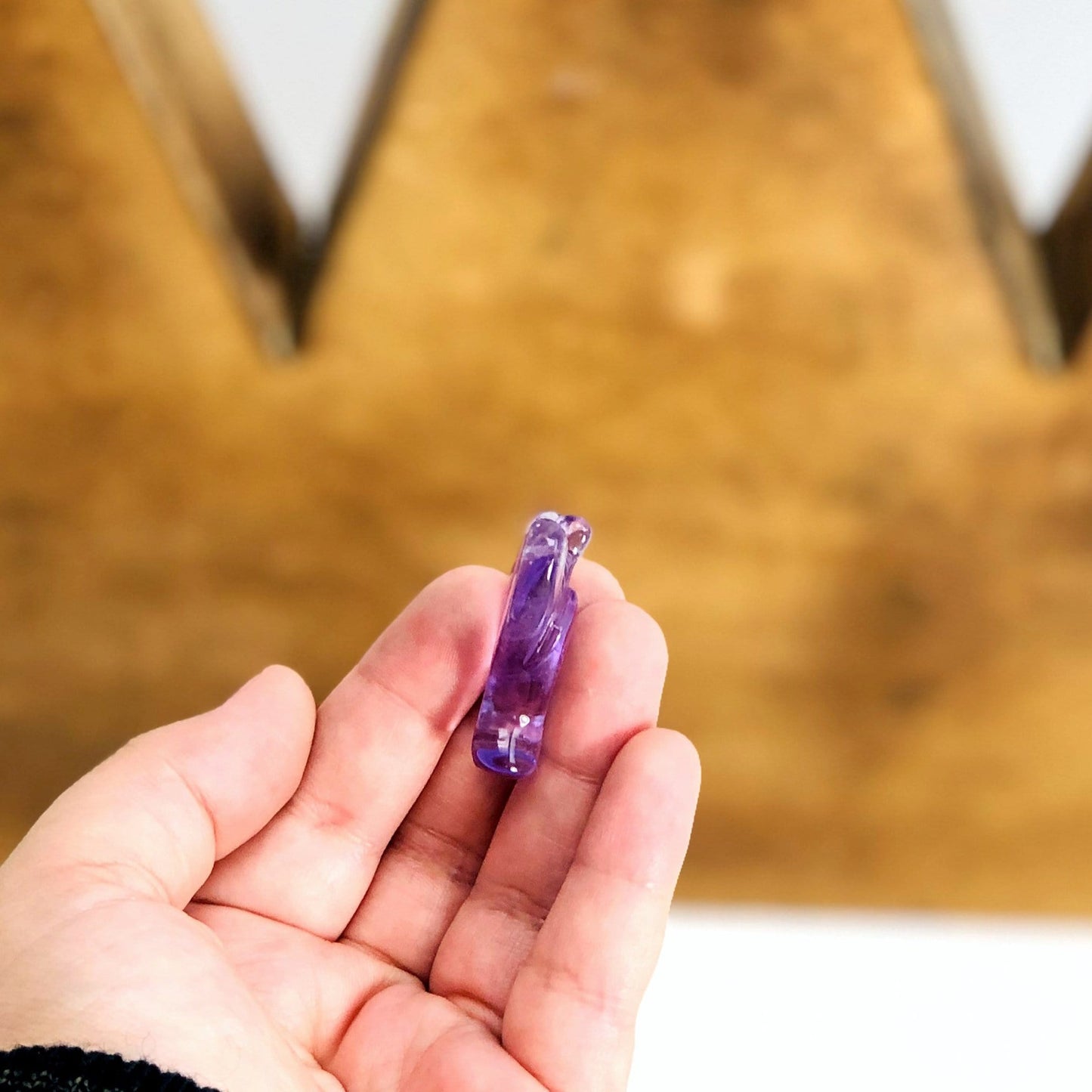 amethyst displayed on its side for thickness reference