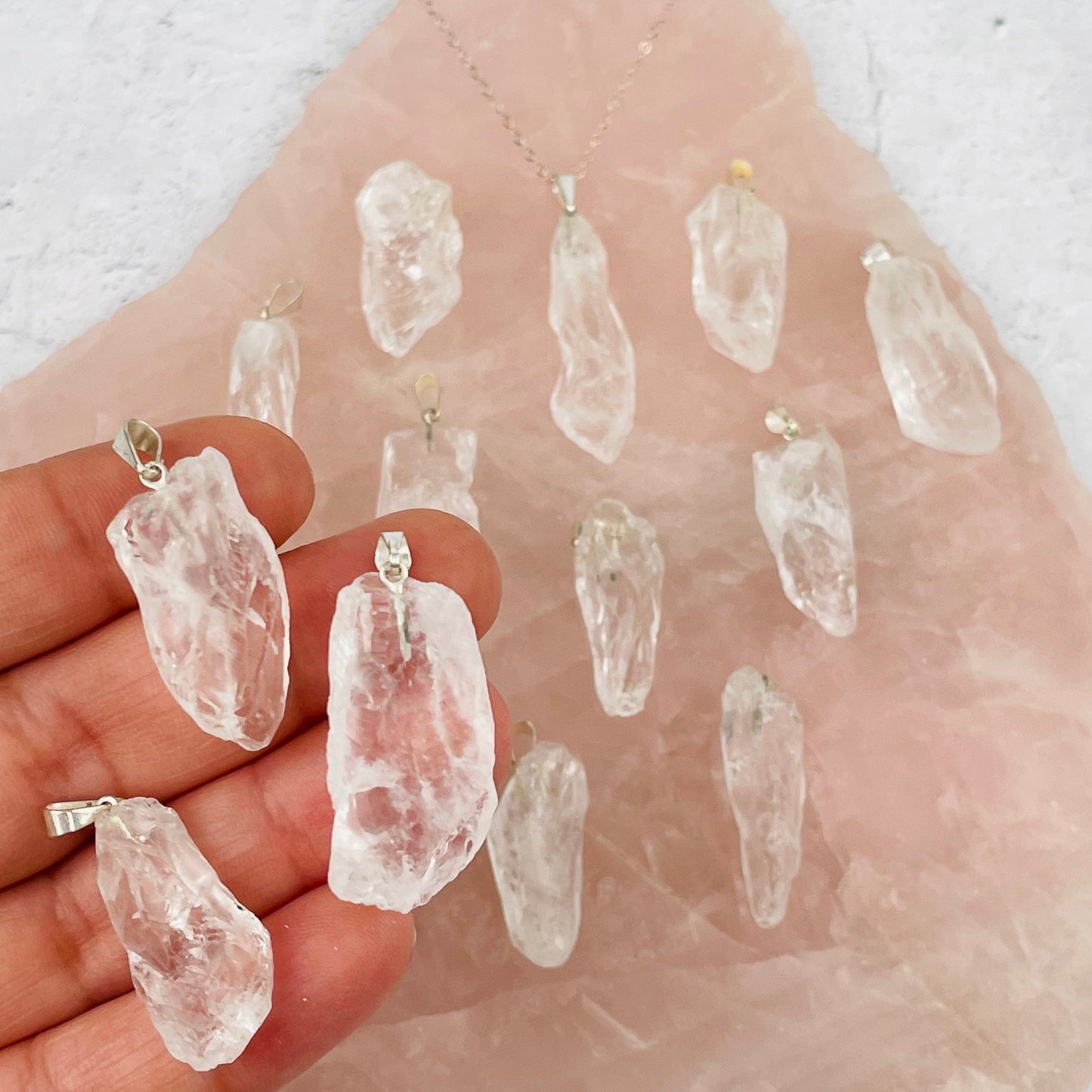 Crystal Quartz - Rough Stone Pendants with Silver Plated Bail in hand for size reference
