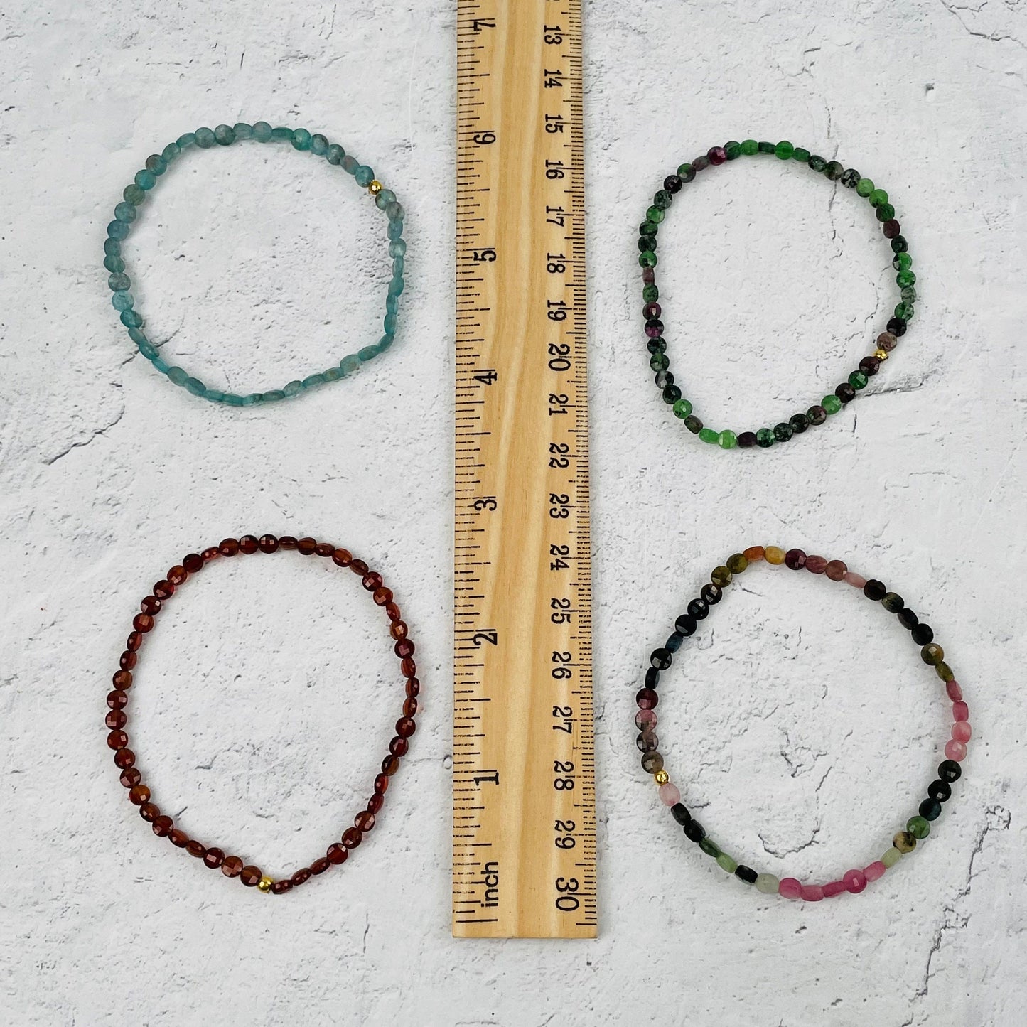 bracelets next to a ruler for size reference