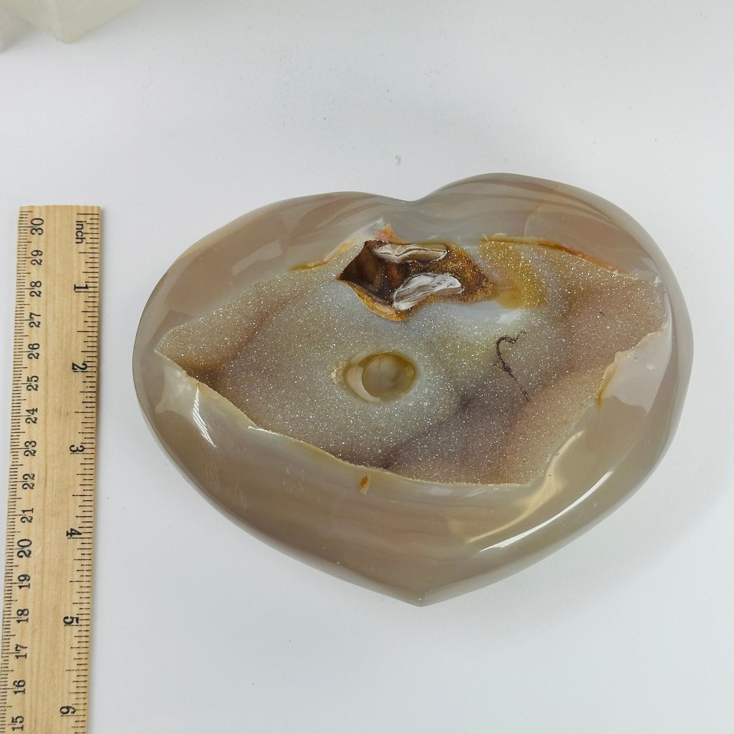 agate heart next to a ruler for size reference