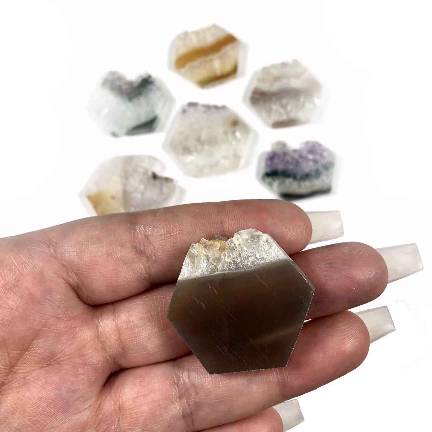 small hexagon displayed in hand for size reference