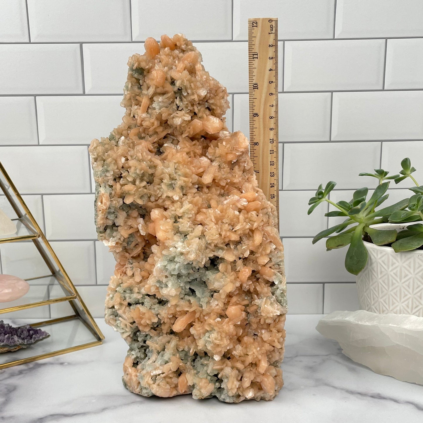 Peach Zeolite And Green Apophyllite Formation next to a ruler for size reference