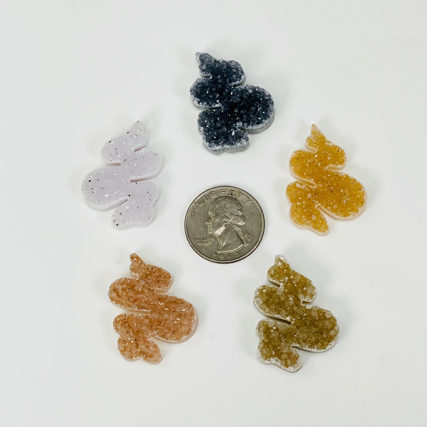 snake cabochons next to a quarter for size reference