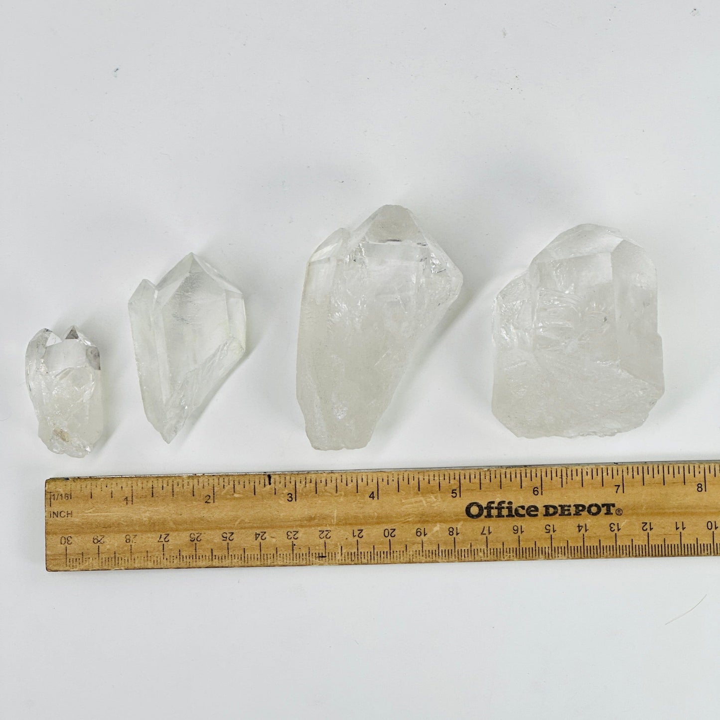 crystal quartz points next to a ruler for size reference