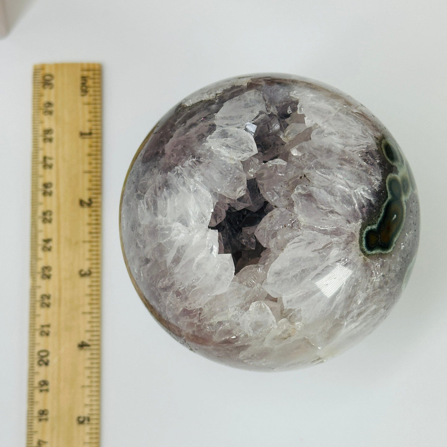 amethyst sphere next to a ruler for size reference
