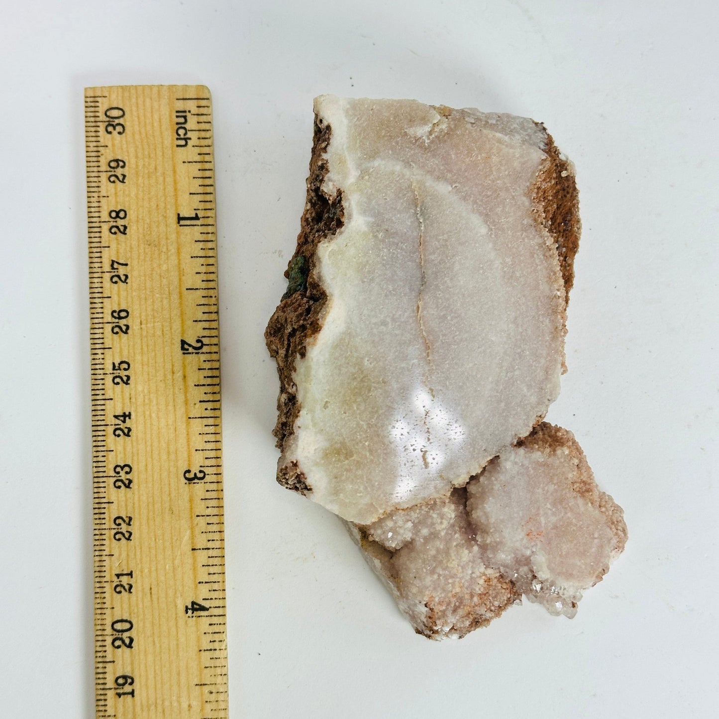 pink amethyst next to a ruler for size reference
