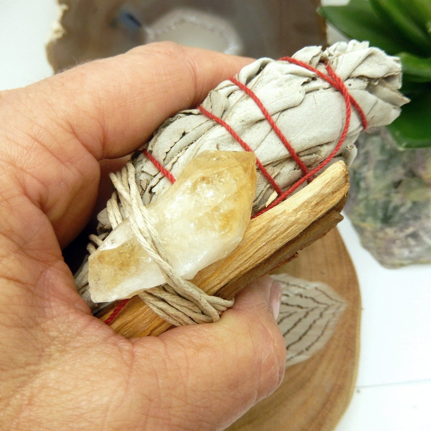 sage bundle with citrine in hand for size reference and possible variation