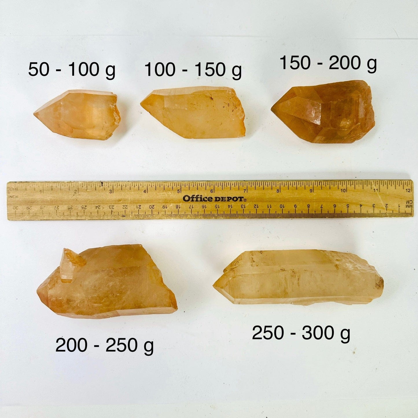 Lemurian Tangerine Quartz Point - High Quality - By Weight five quartz points of different weight categories next to ruler for size reference