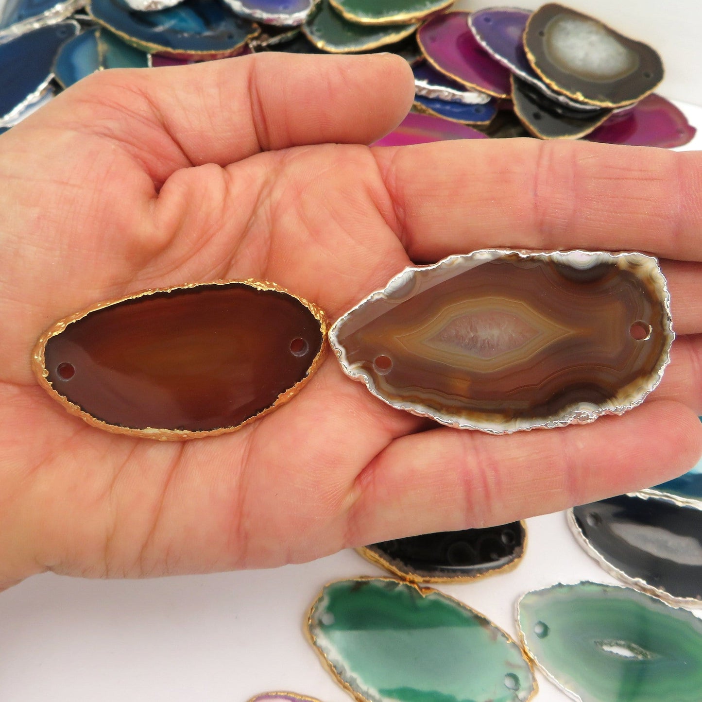 Picture of our orange/ red agate slices plated edge being displayed, for both options silver and gold.
