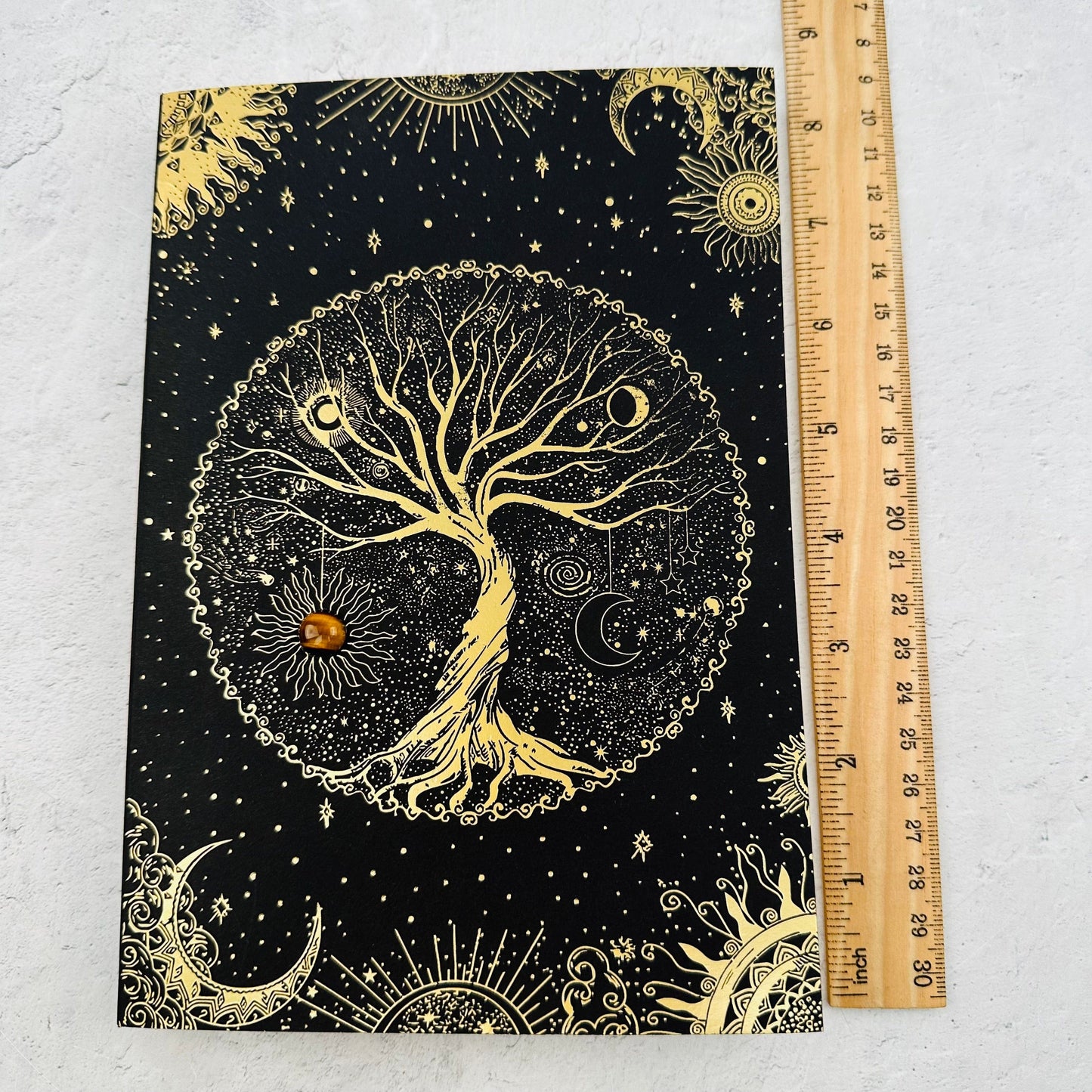 journal next to a ruler for size reference