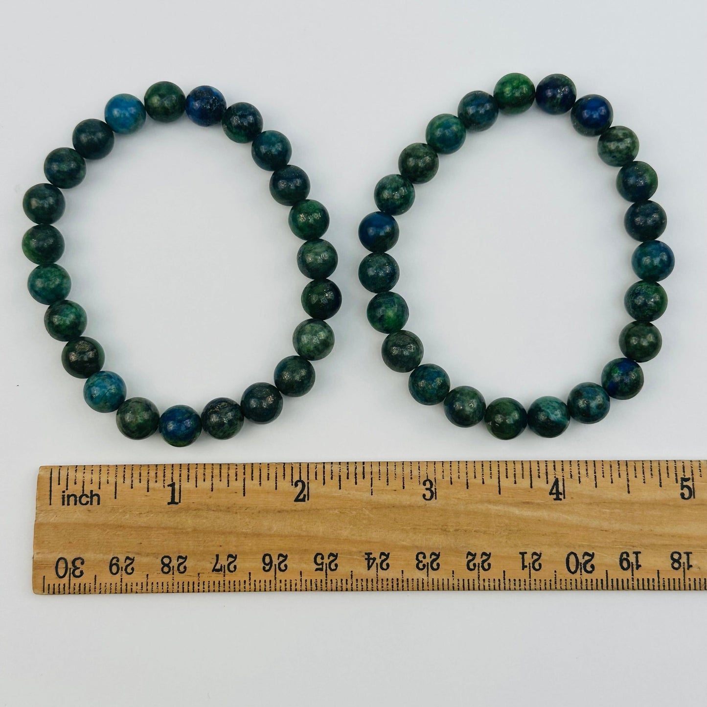 bracelets next to a ruler for size reference