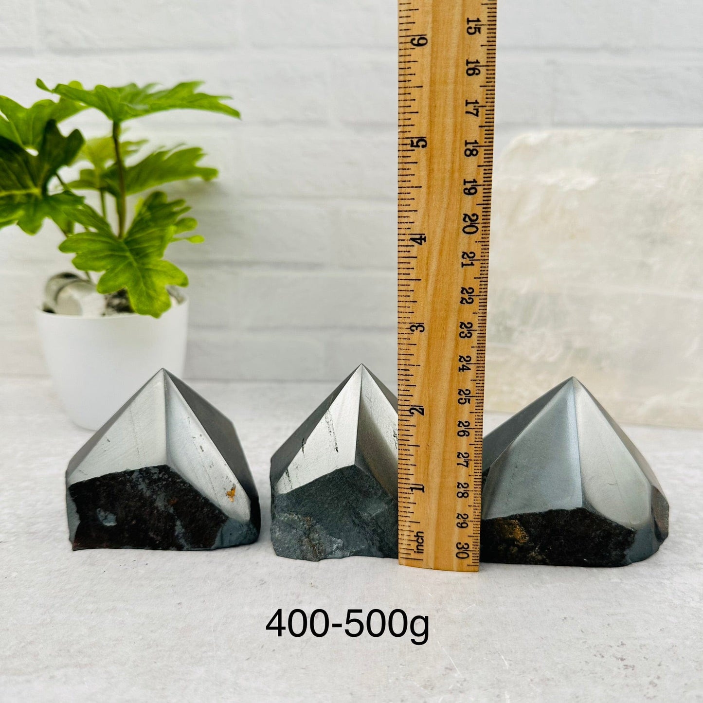 Hematite Semi-Polished Points - By Weight next to a ruler for size reference