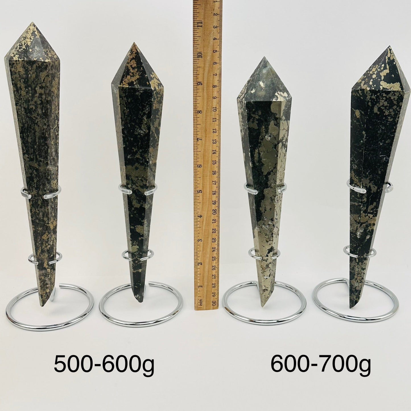 crystal wands on metal stand are sold by weight. displayed next to a ruler for size reference