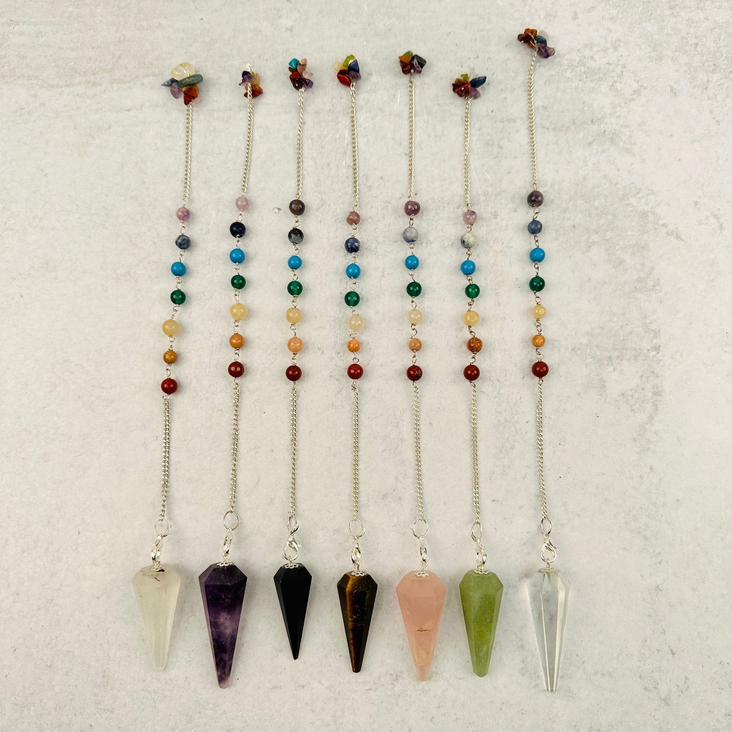 Crystal Pendulums on Chakra Chain displayed to show the differences in the crystal types