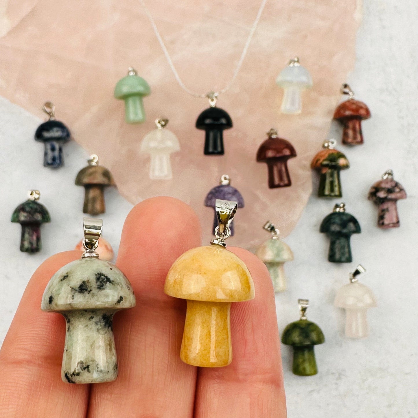 mushroom pendants in hand for size reference