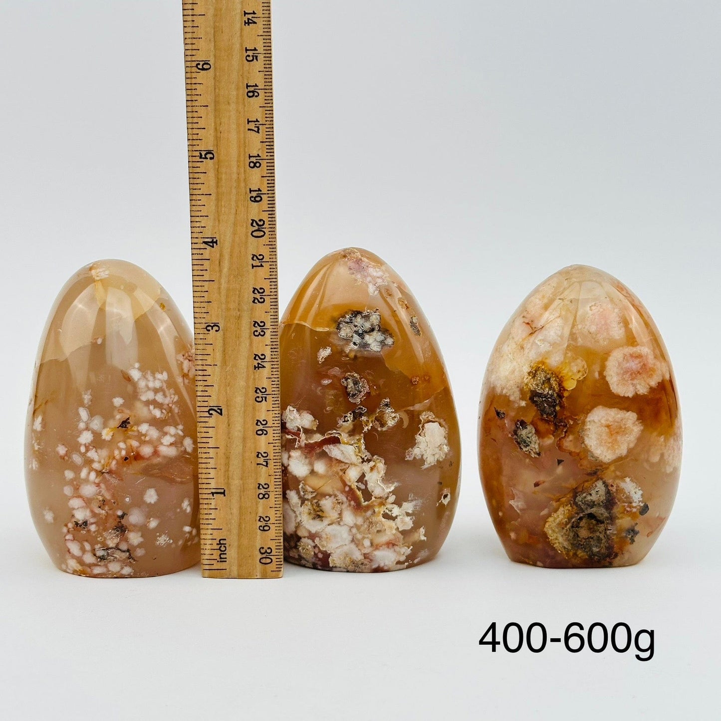 flower agate cut bases sold by weight. displayed next to a ruler for size reference