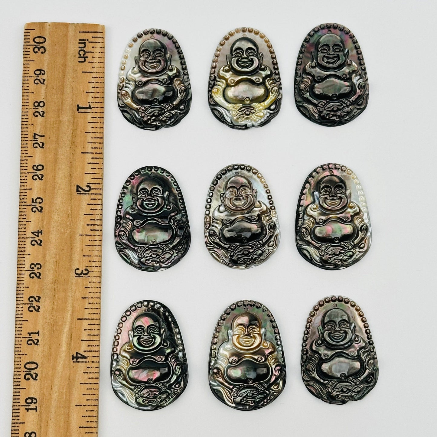 pendants next to a ruler for size reference