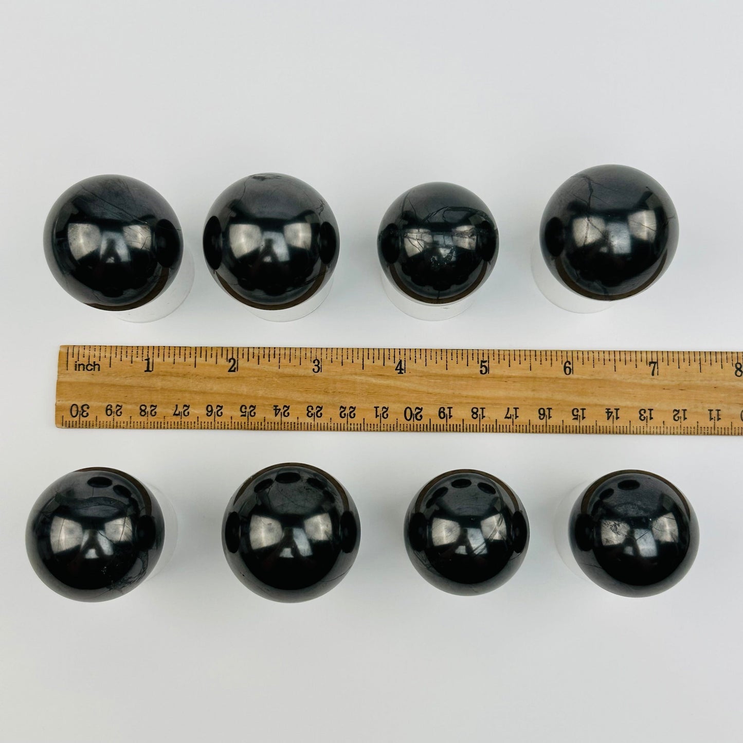 spheres displayed next to a ruler for size reference