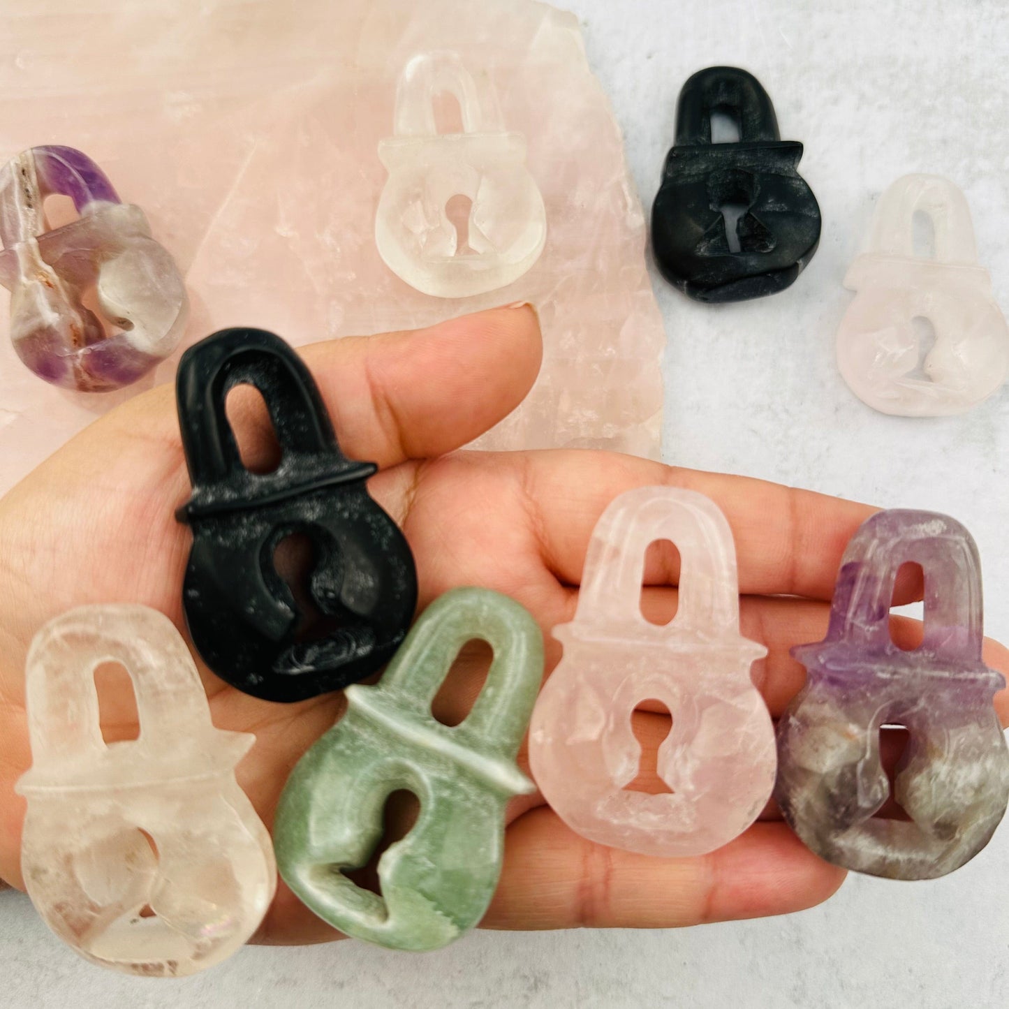 multiple gemstone locks in hand for size reference