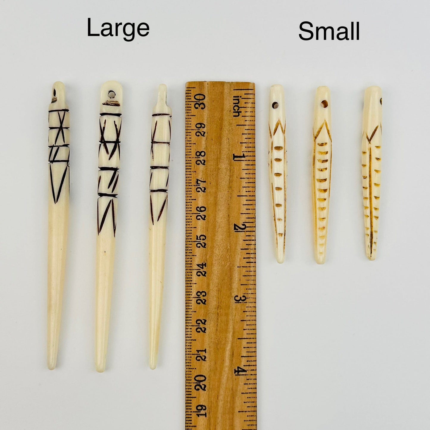 beads next to a ruler for size reference