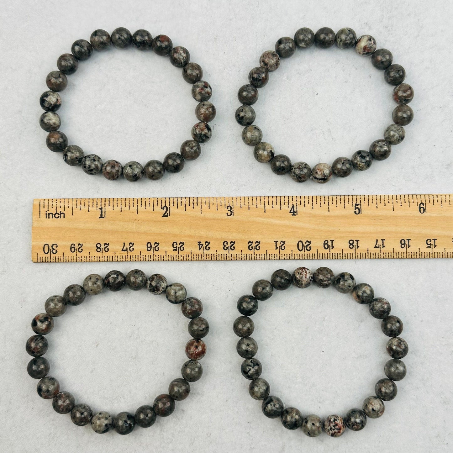 bracelets next to a ruler for size reference