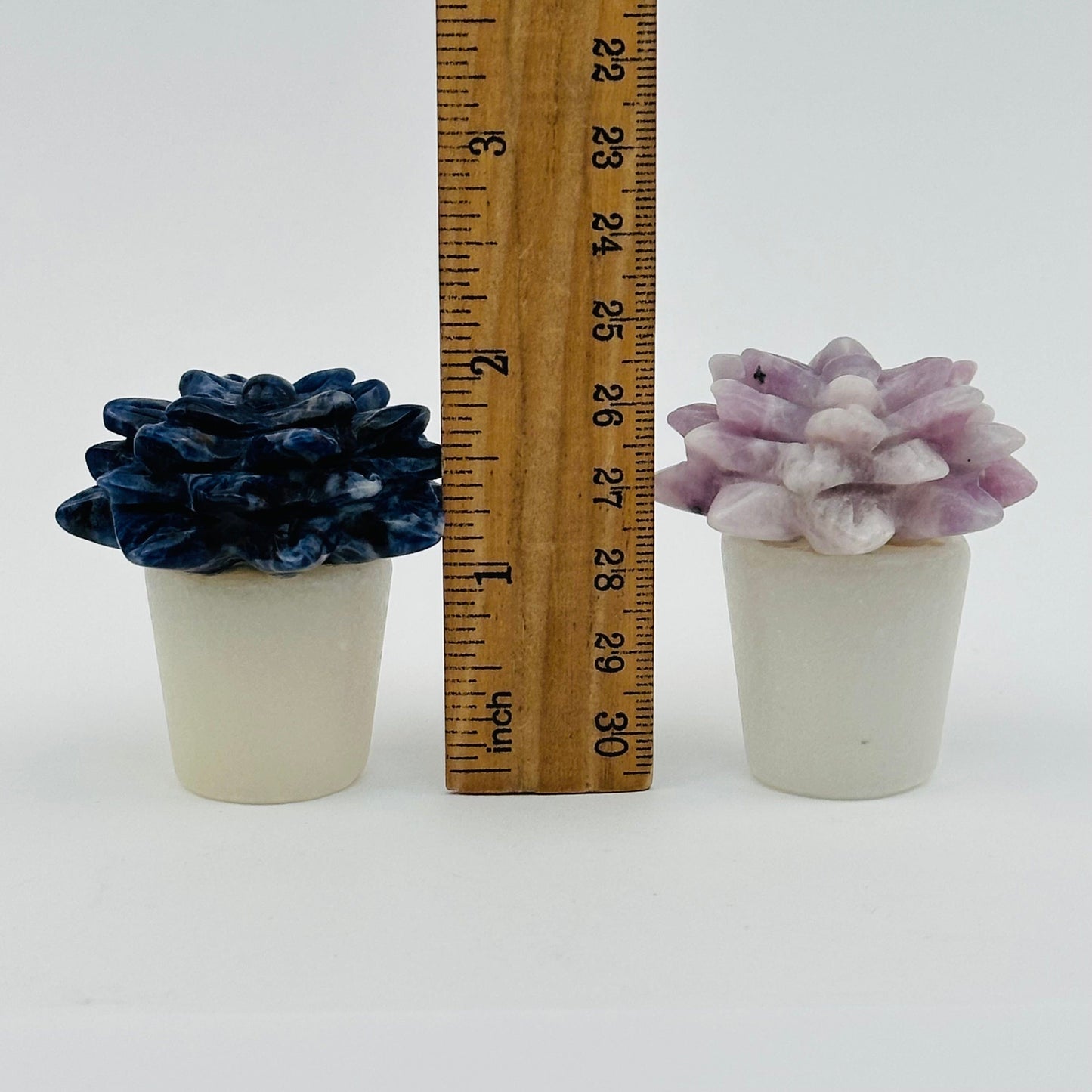 crystal pots next to a ruler for size reference