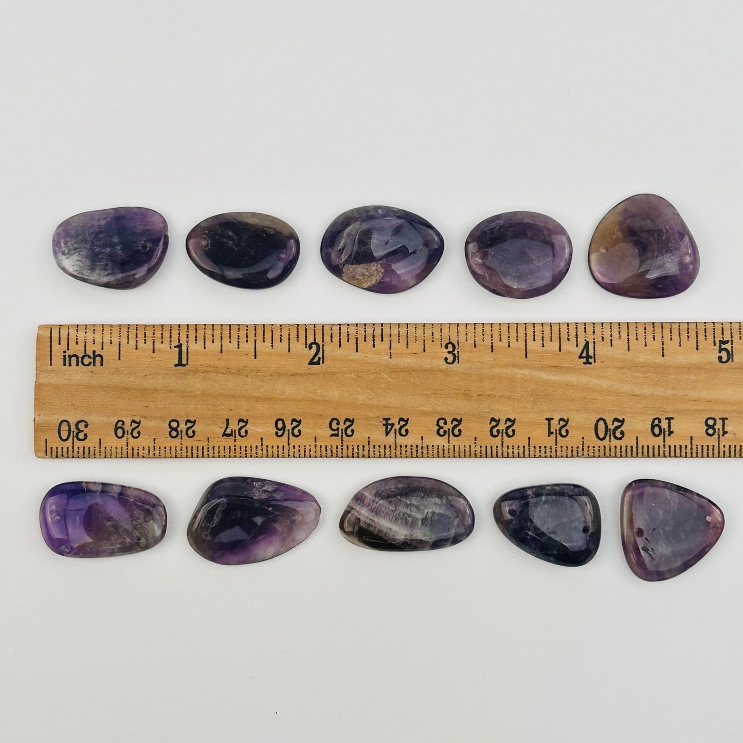 beads displayed next to a ruler for size reference