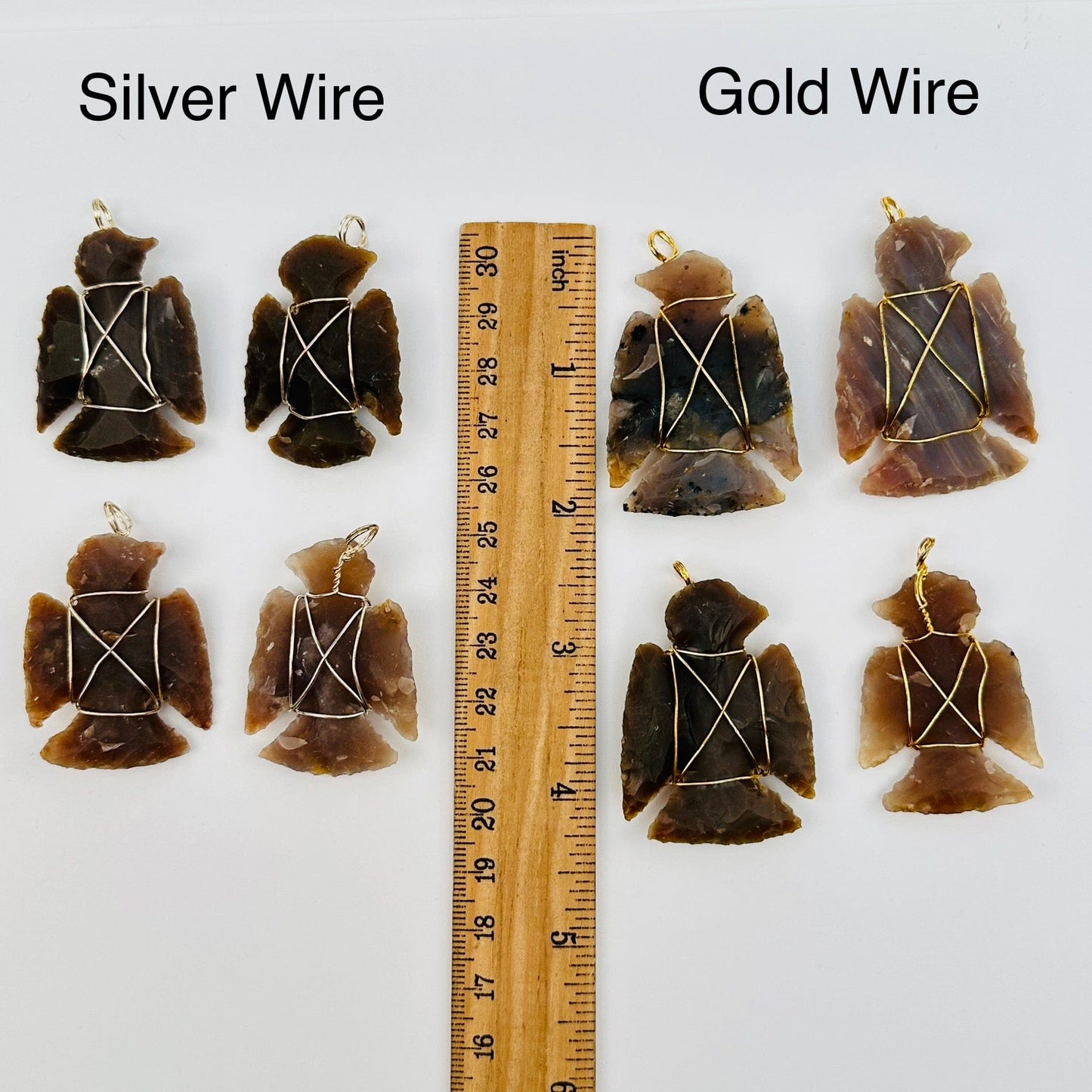 pendants displayed next to a ruler for size reference. available in silver or gold toned wire wrapping