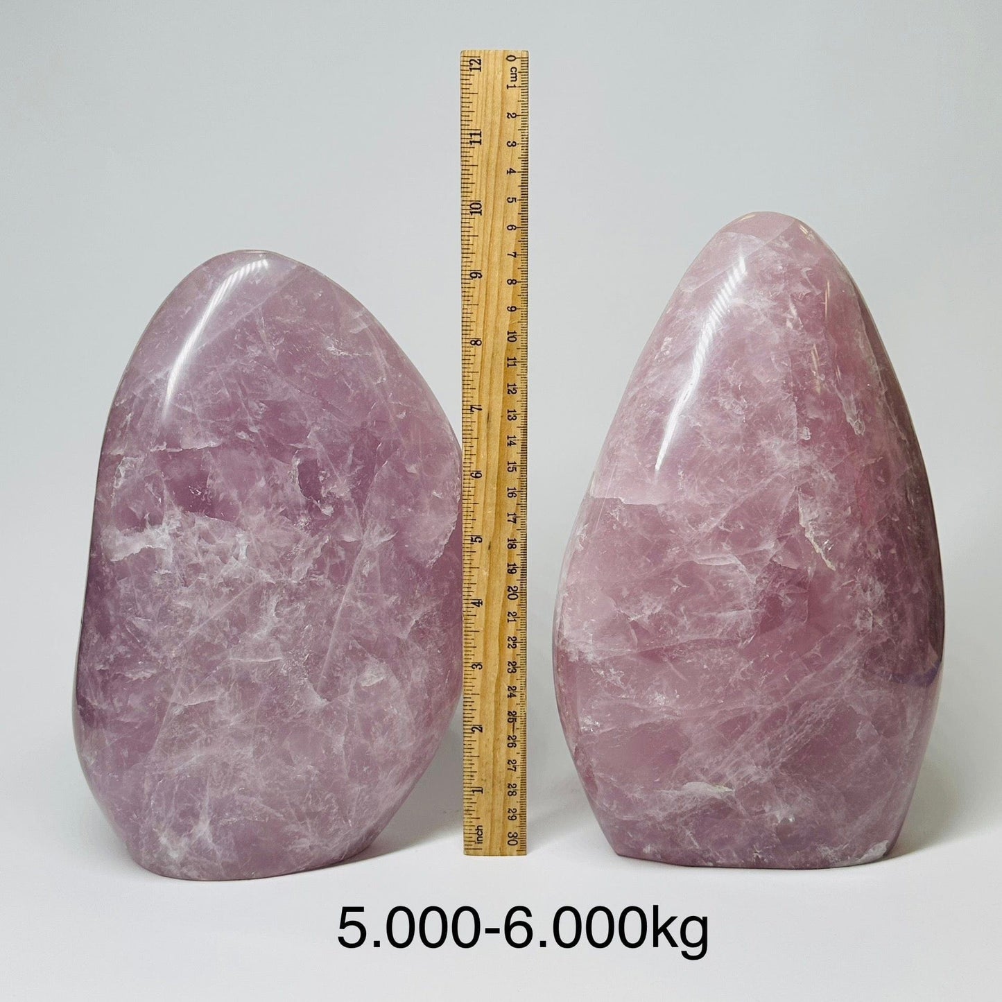 Large Rose Quartz Crystal Cut Base - By Weight displayed next to a ruler for size reference