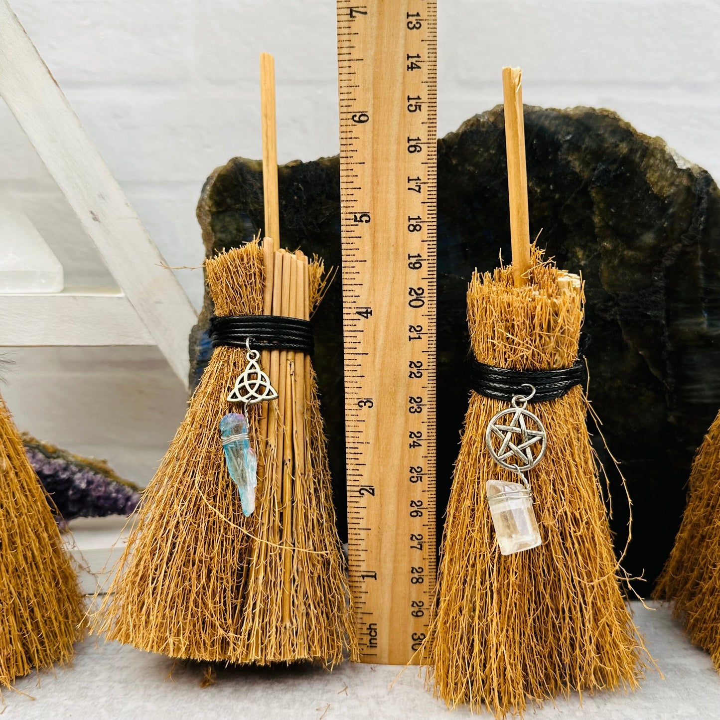 Protection Brooms next to a ruler for size reference