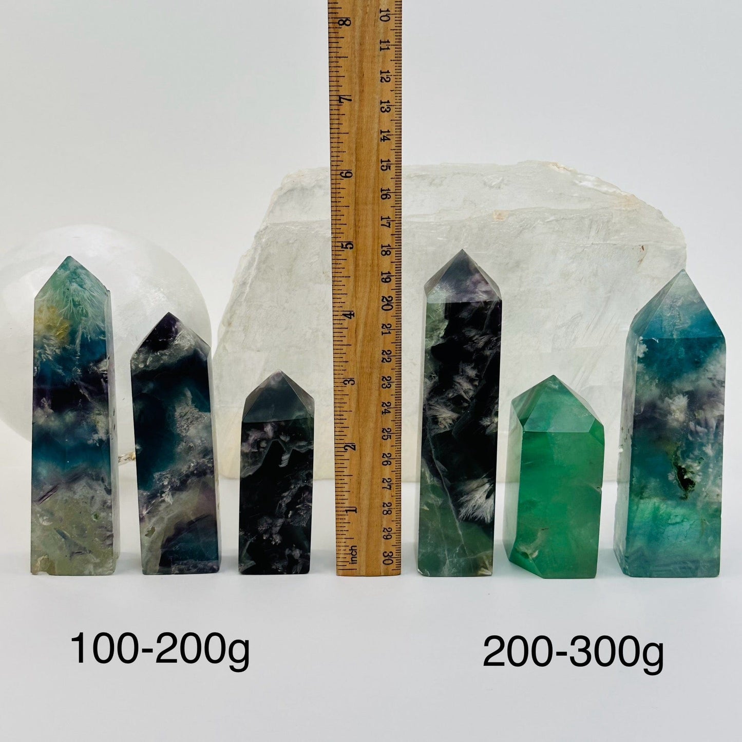 Rainbow Feathered Fluorite Crystal Polished Point Towers - By Weight - next to a ruler for size reference