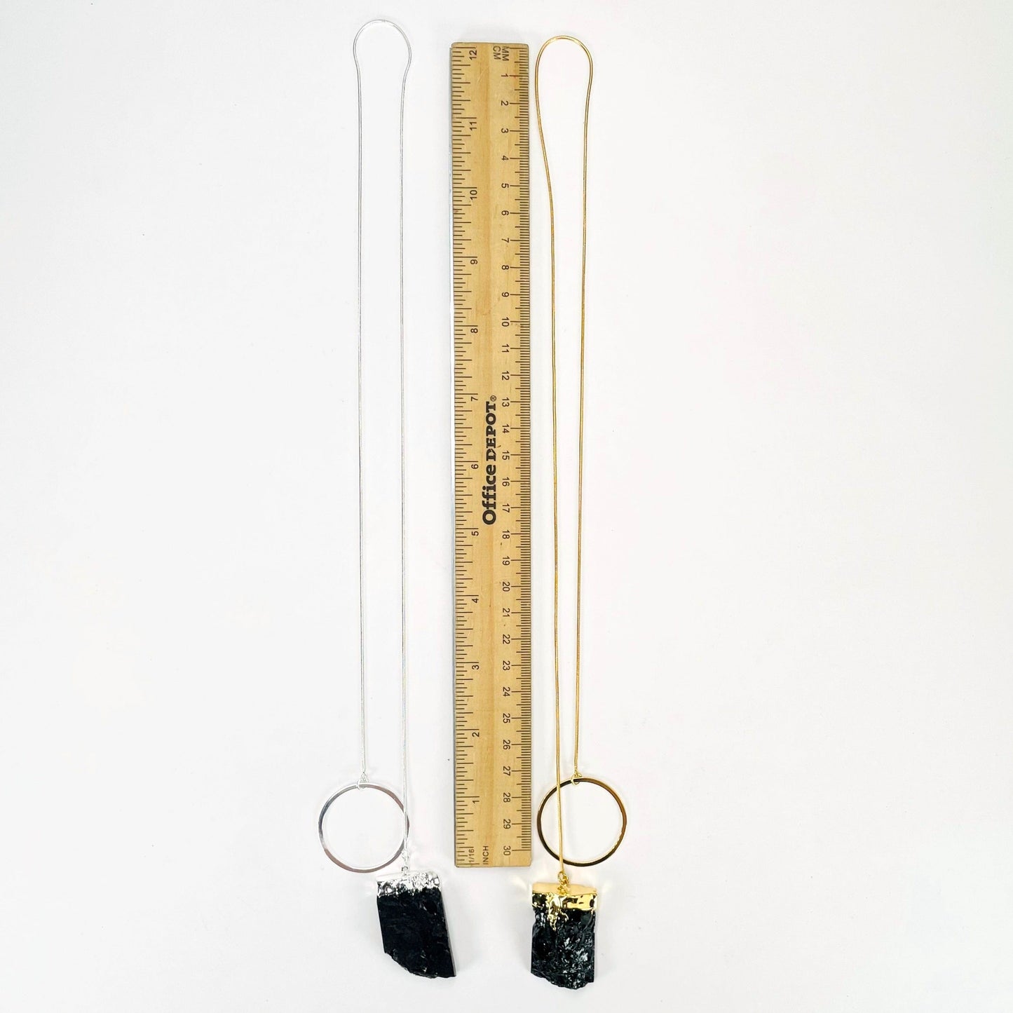 full length of one gold and one silver obsidian chunk adjustable necklace with a ruler for length reference