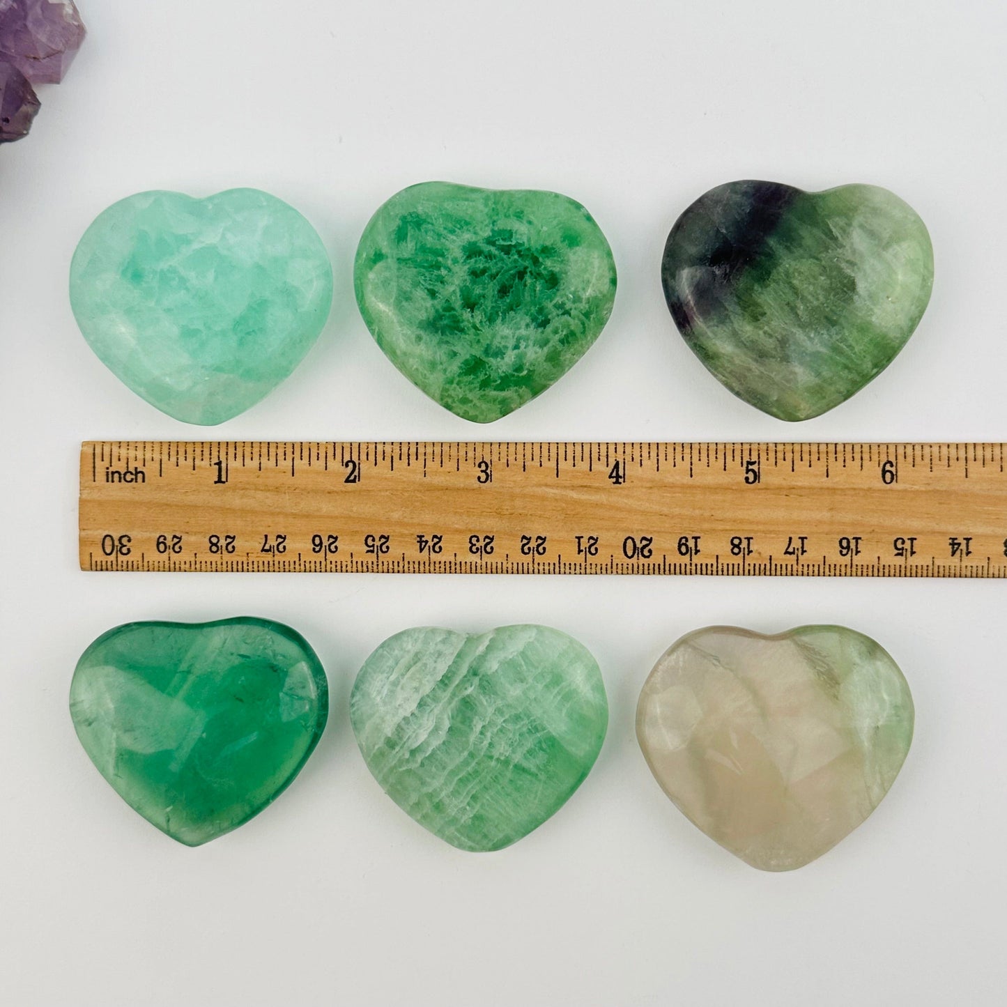 crystals next to a ruler for size reference