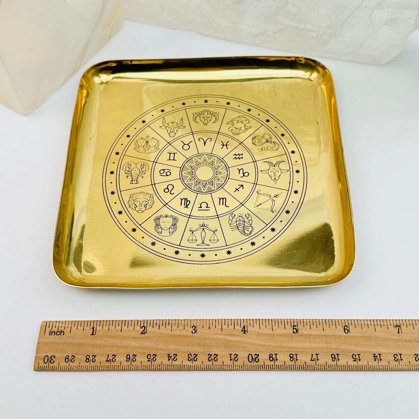 brass tray next to a ruler for size reference