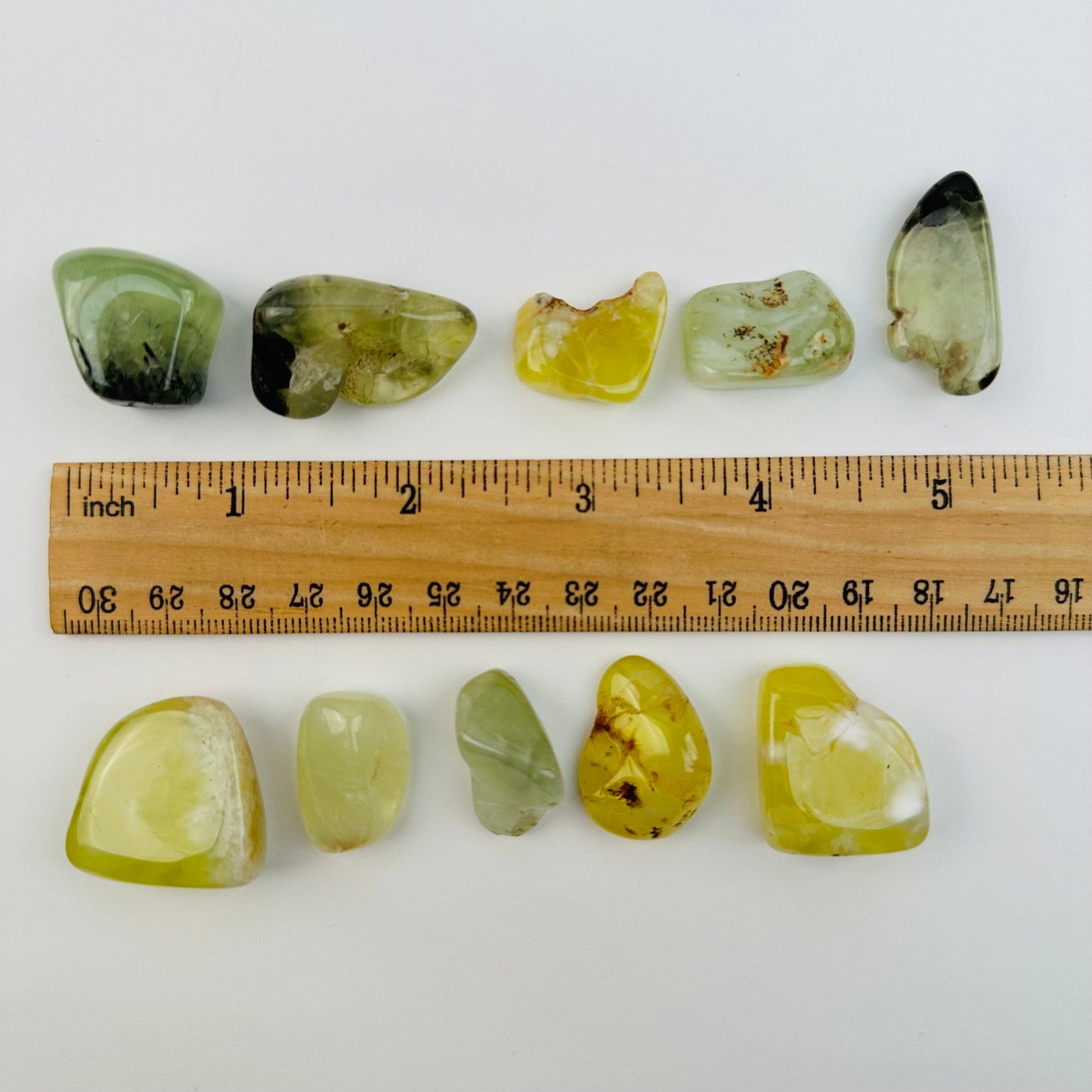 Tumbled Prehnite Stone - High Quality - next to a ruler for size reference