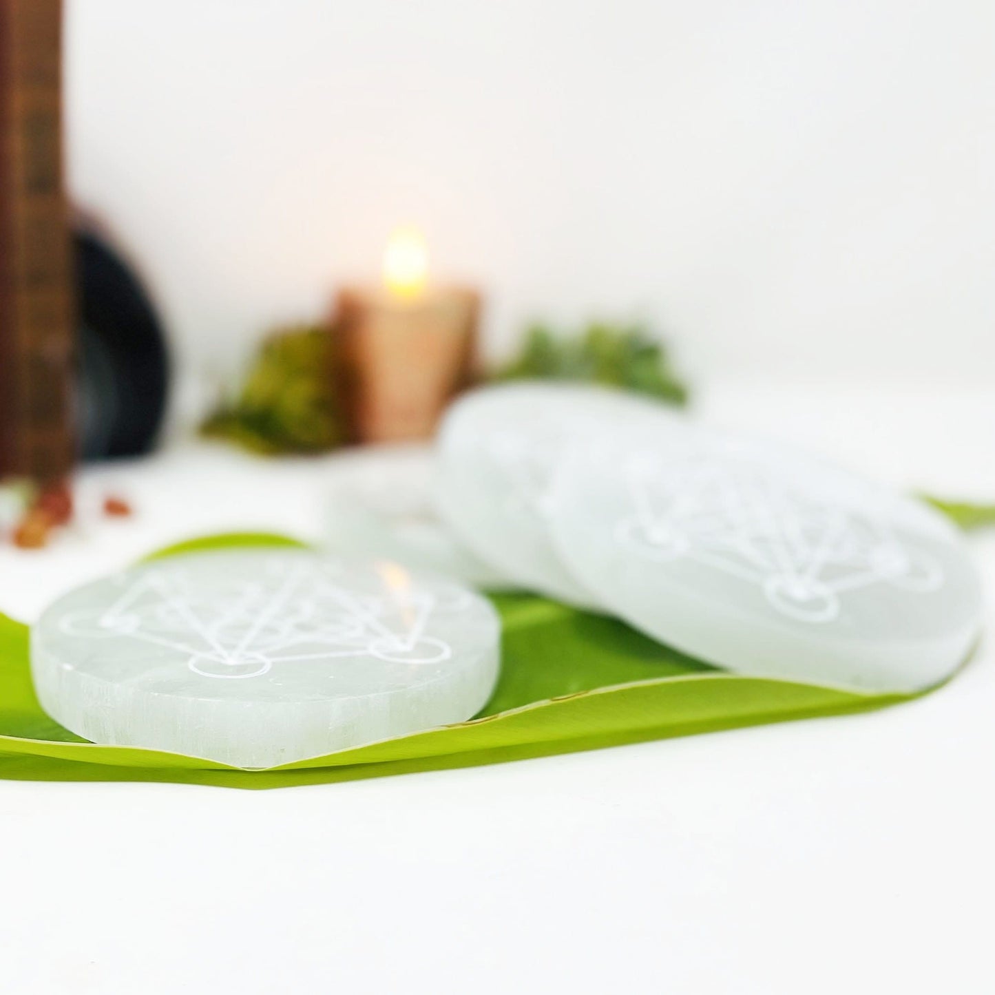 side view of selenite rounds with metatron engraving for thickness