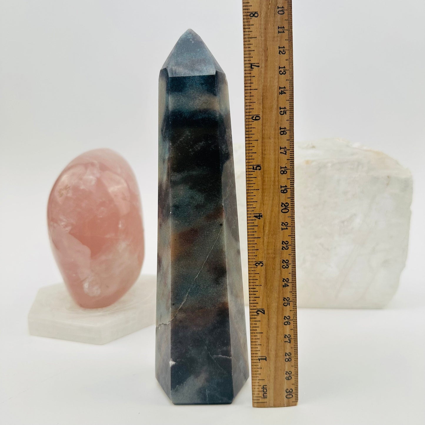 polished trolleite crystal point displayed next to a ruler for size reference