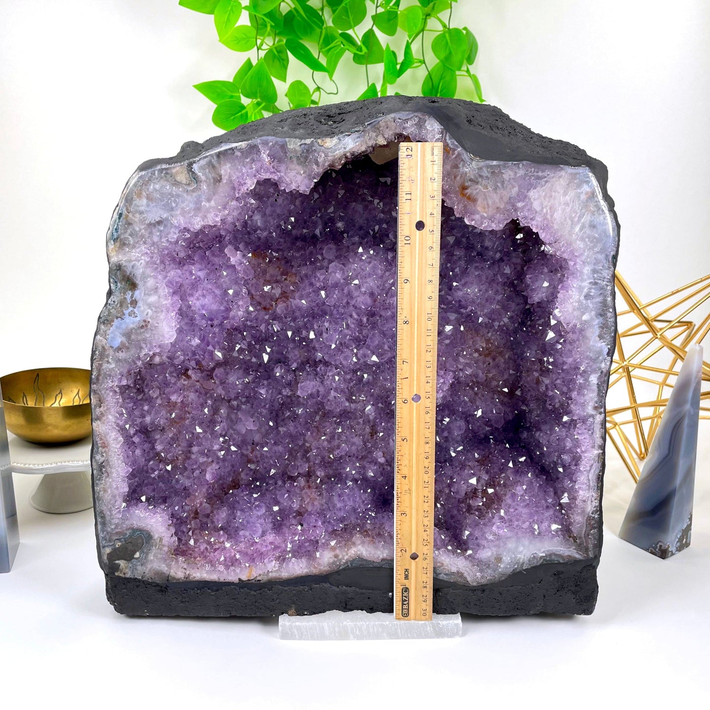 front of amethyst cave geode with vertical ruler for height