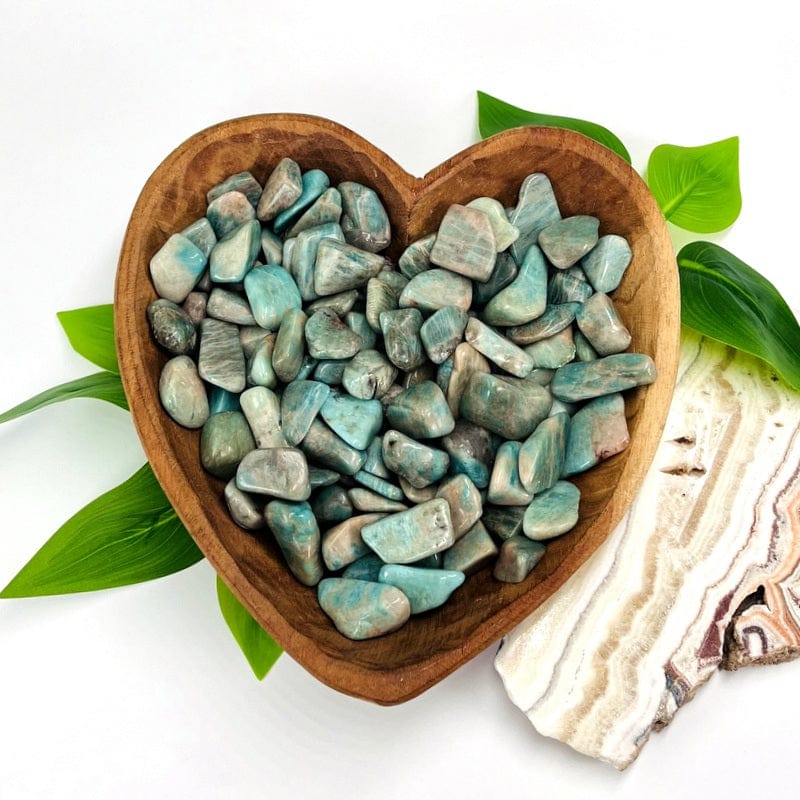 one pound of amazonite tumbled stones in a wooden heart bowl set up as home decor