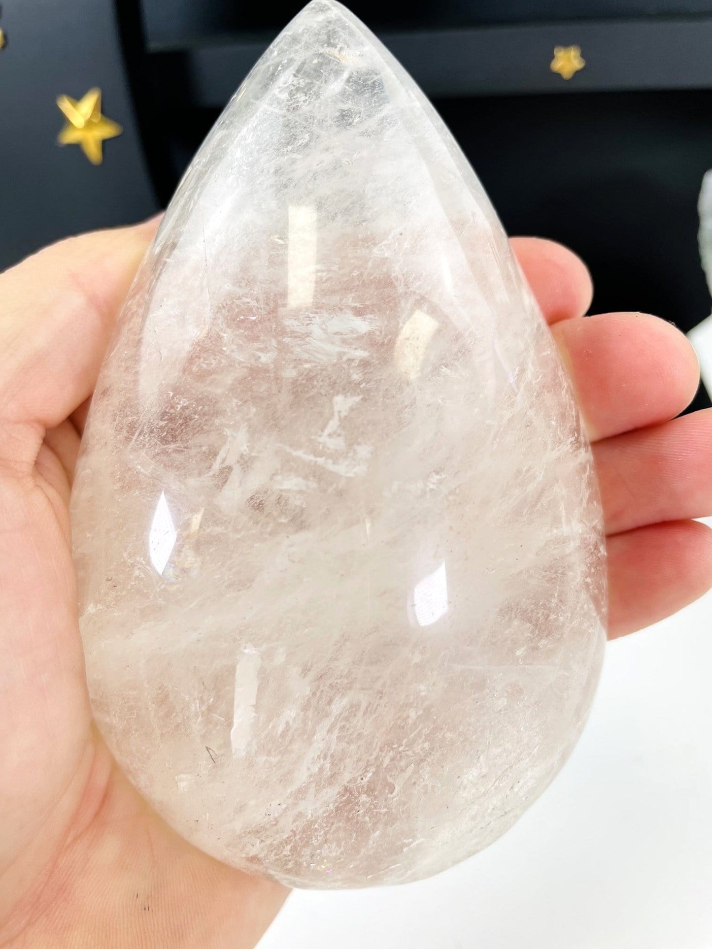 hand holding up Clear Quartz Tear Drop Shape