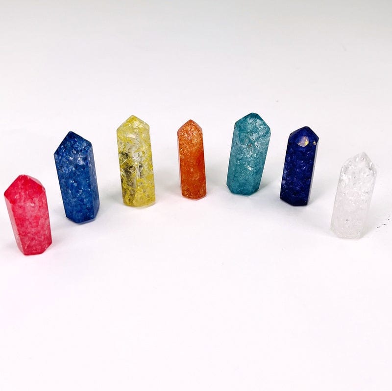 multiple crackled quartz pencil points displayed to show the differences in the possible sizes