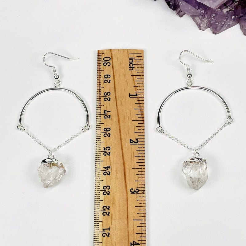 earrings next to a ruler for size reference