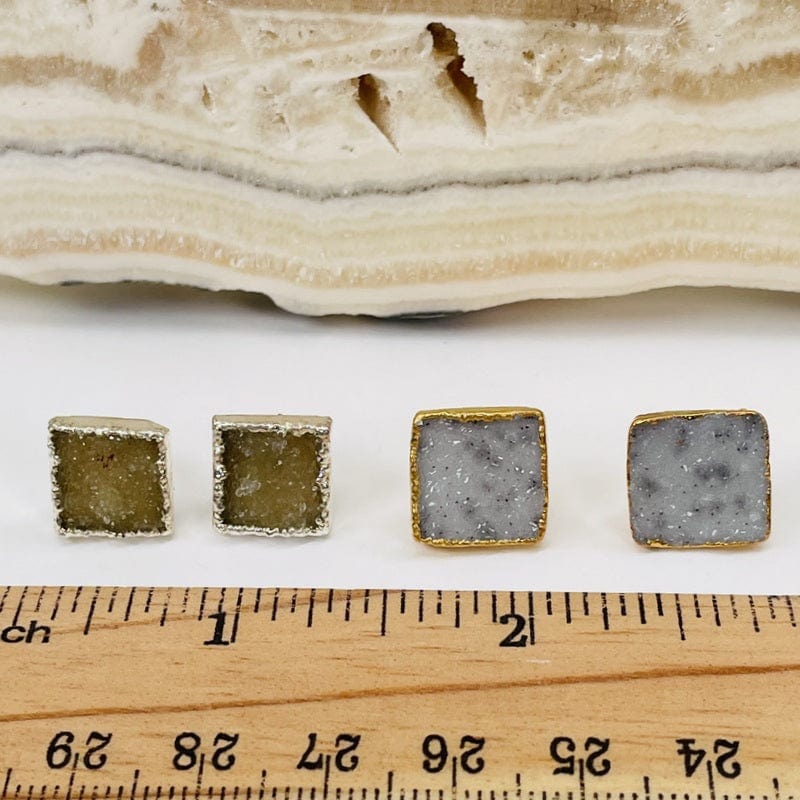 earrings next to a ruler for size reference