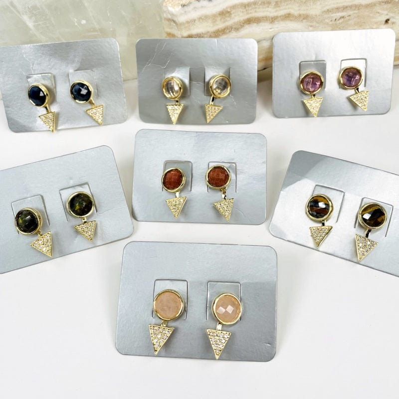 multiple earrings displayed to show the differences in the gemstones